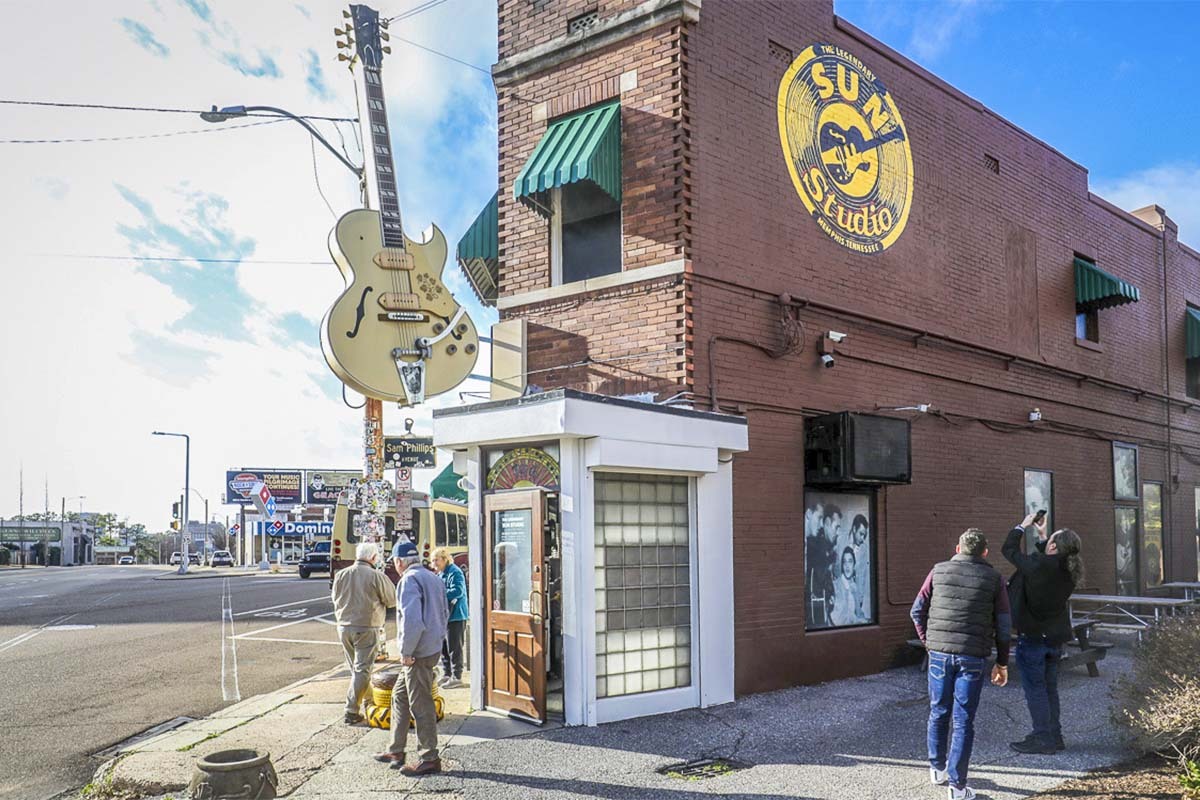 A tourist snaps a photo of the golden Sun Studio logo on the second floor of the famous landmark. Out front, a giant guitar greets you, as well.