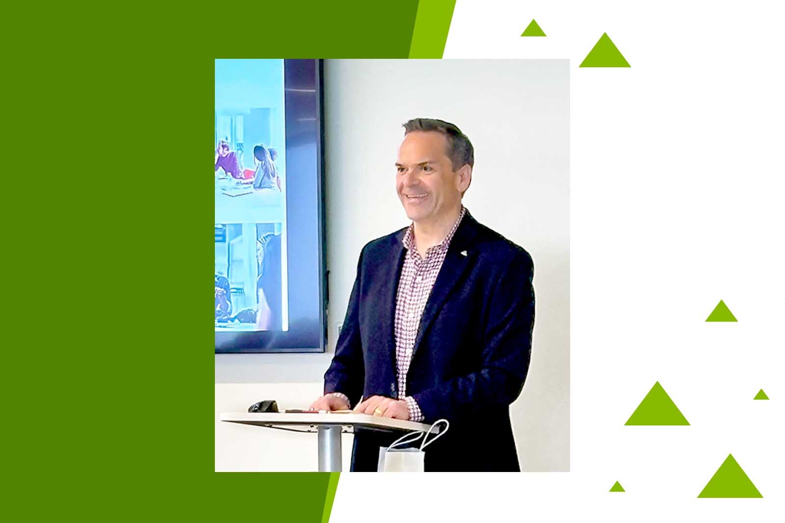 Chief Governance Officer Andrew Nix speaking at a podium in...