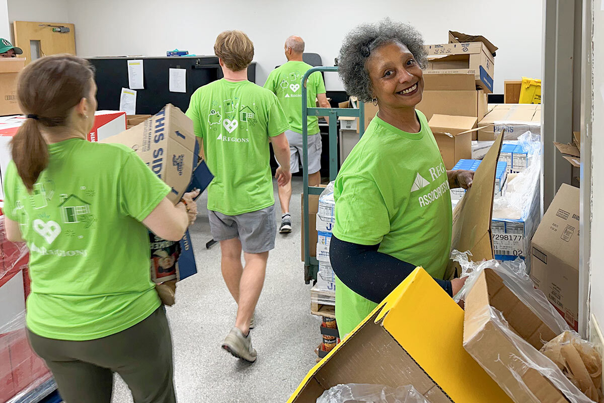Regions Foundation and Regions Bank associates helping with the tornadoes after facts by packaging and distributing food.