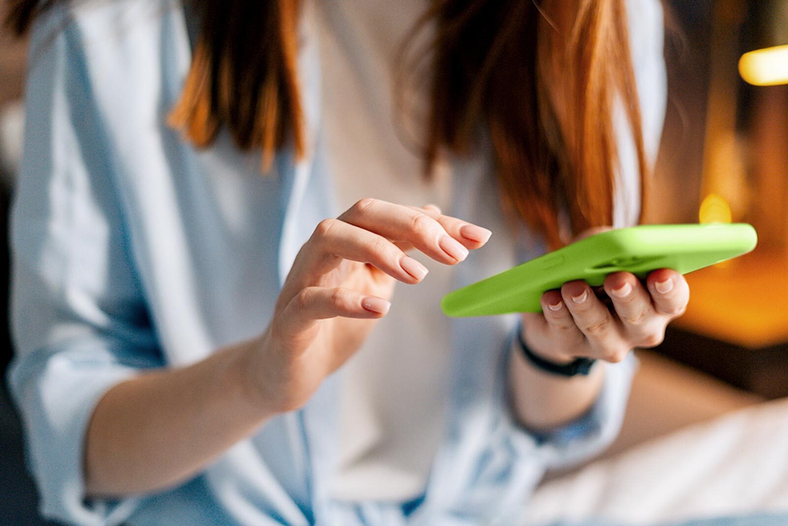 Woman making a payment to a friend on mobile cellphone.