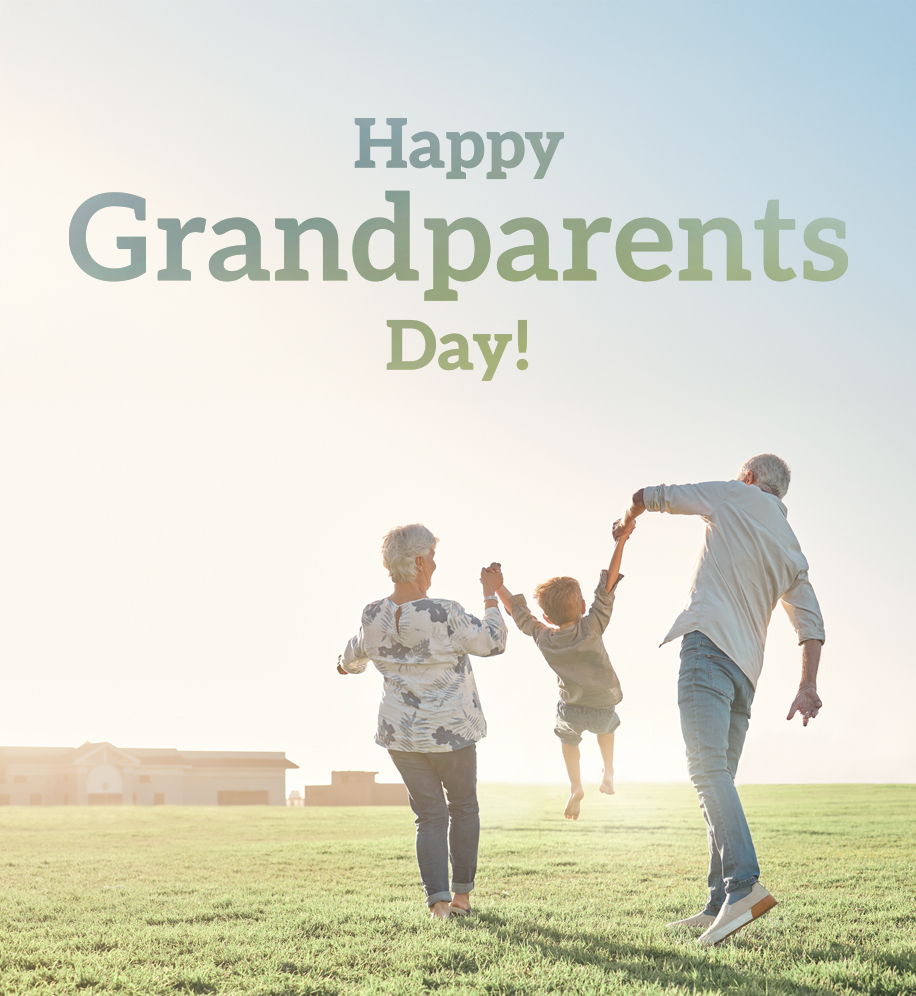 Grandparents swinging grandchild between them as they walk. Text: Happy Grandparents Day.