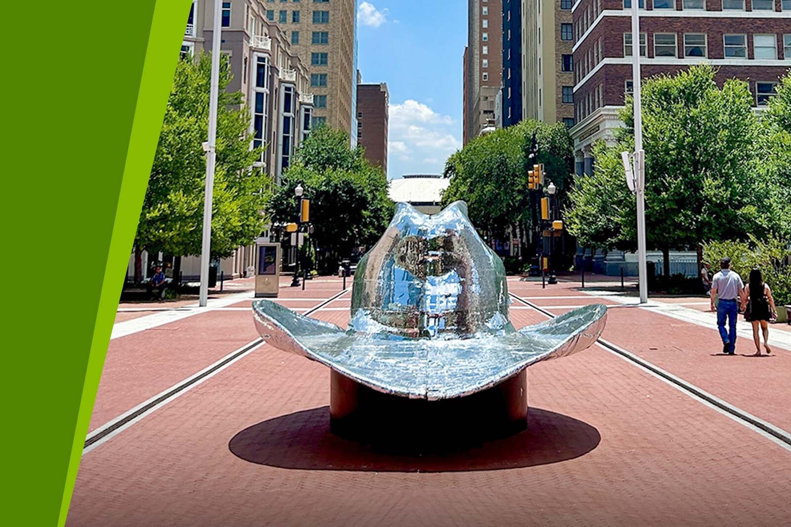 Close up of silver cowboy hat statue in downtown Fort...