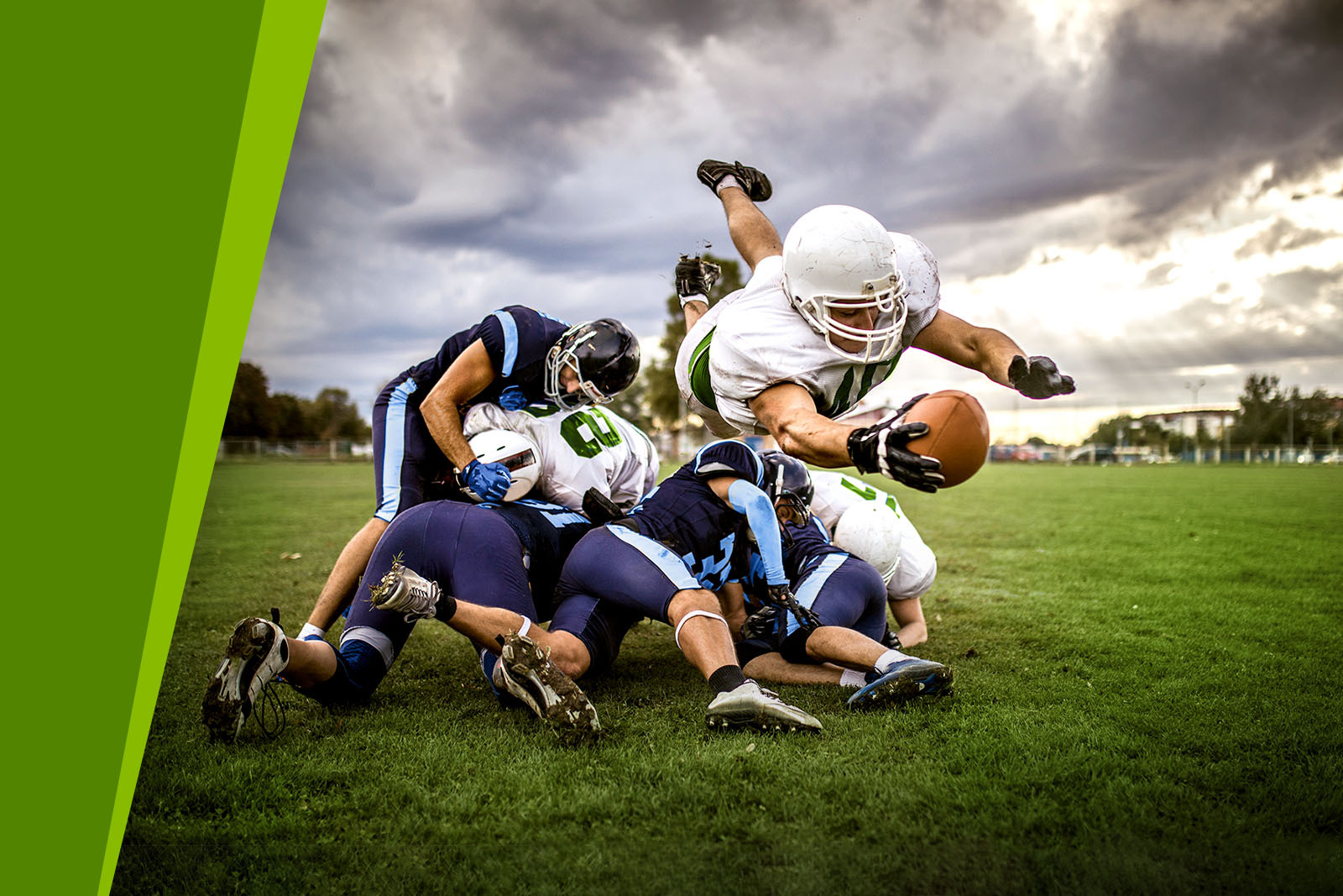 Dramatic photo of a football tackle with the person holding...