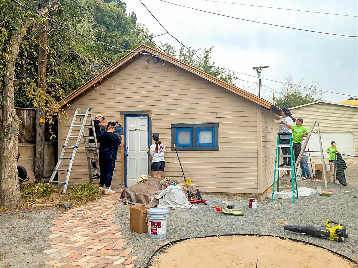 "Before" Image of a team of volunteers painting a garage.