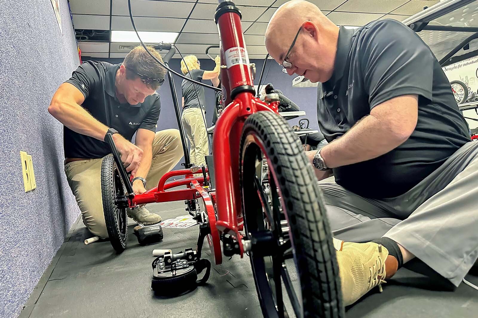 Regions Bank volunteers assembling trikes at Iron City Trykes in Alabama.
