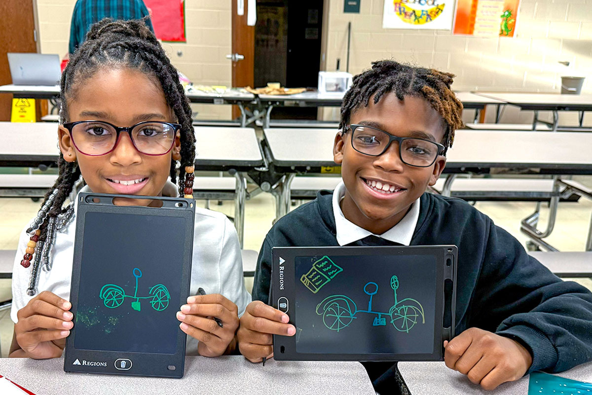 Miles of Smiles Regions initiative in Jackson, Tennessee — two childeren with tablets.