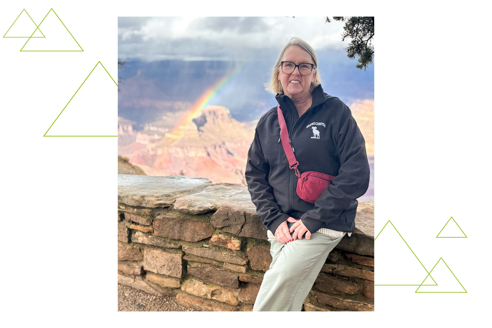 Virginia Kelley at the Grand Canyon overlook with a rainbow in the background.