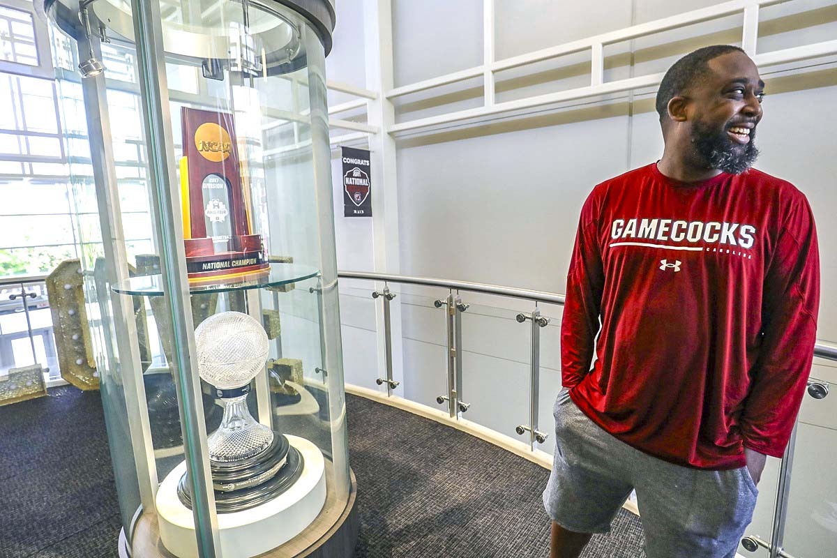 South Carolina’s Freddy Ready grins as he shows off a pair of national championship trophies during the Lady Gamecocks run to national prominence in women’s basketball. If the start of SEC play is an indication, South Carolina will need a bigger trophy case.