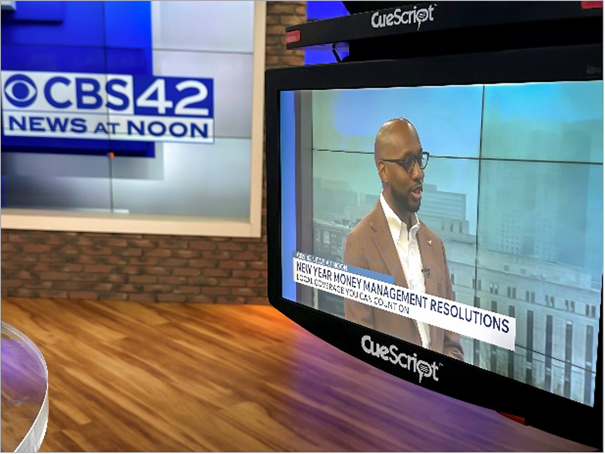 close up of a screen at CBS 42 news station showing a man with a caption that reads, "New Year Money Management Resolutions."