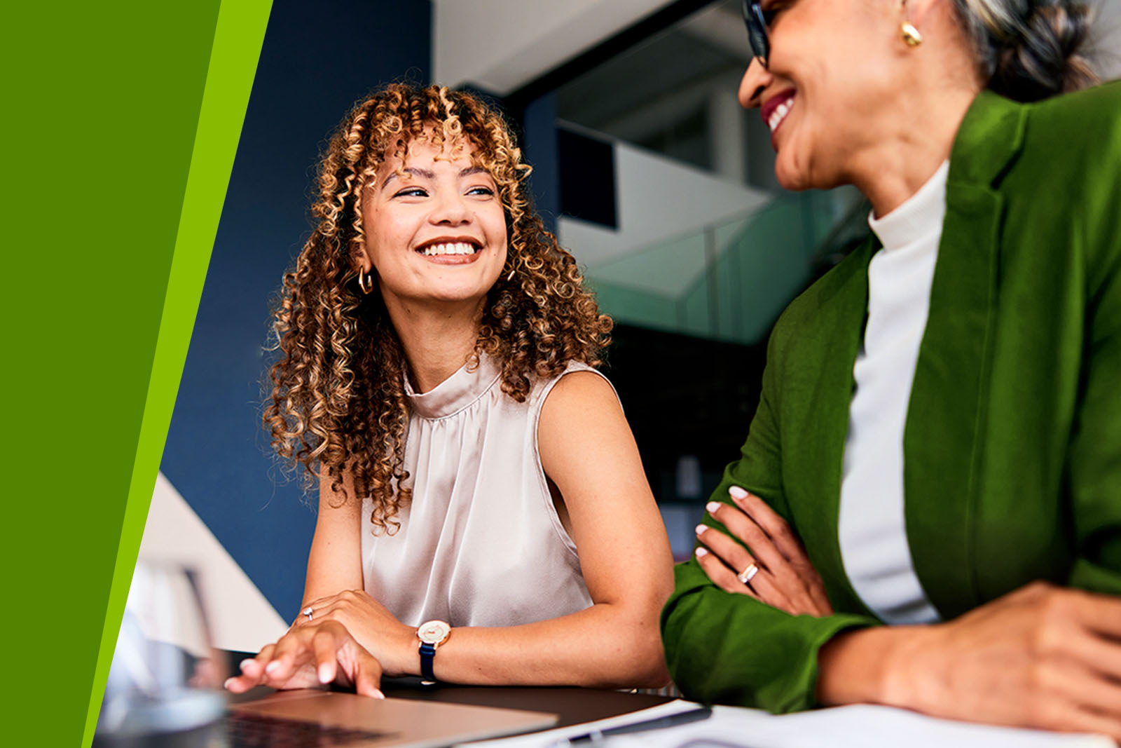 Young and mature business professional females sitting in office environment.