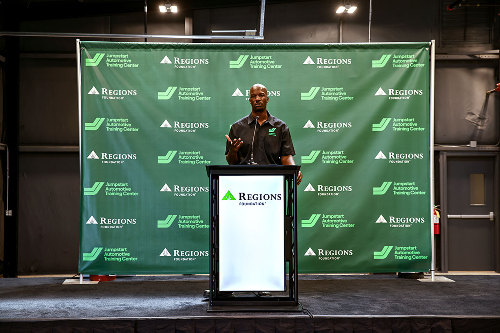 Larry Witherspoon, executive director of Jumpstart Automotive speaking behind podium.