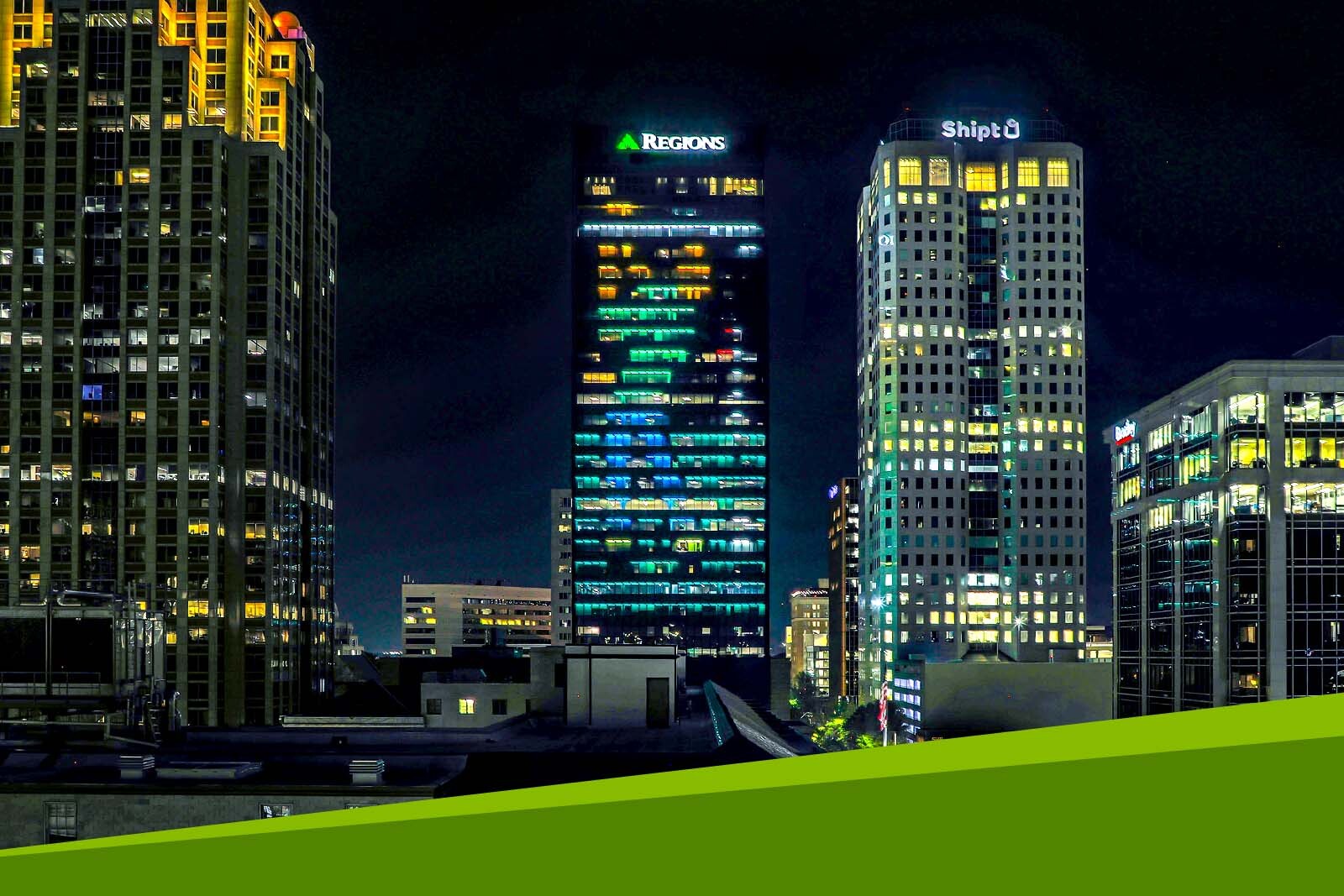 Regions Tradition golfer illuminated lights on Regions Center.