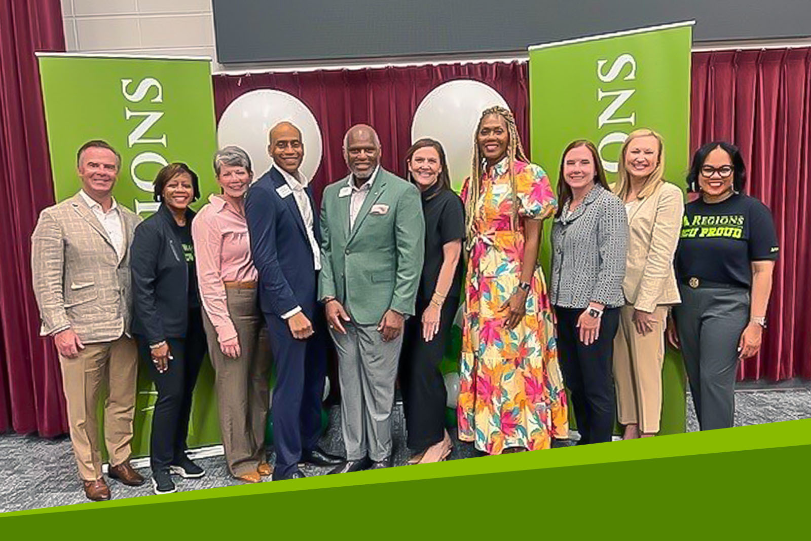 Regions associates gathered in front of Regions banner.