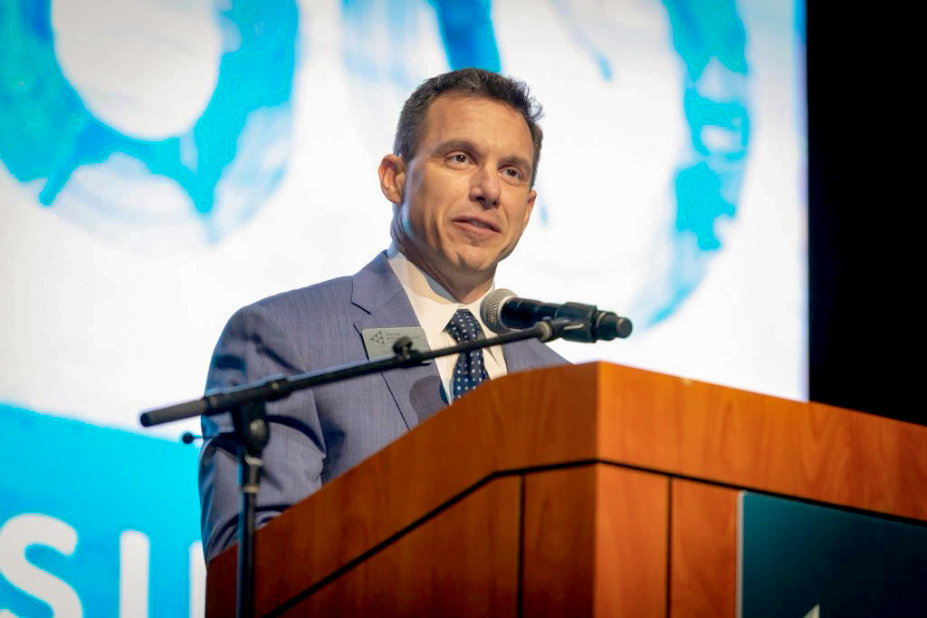 Closeup of Denny Moton speaking at a podium.