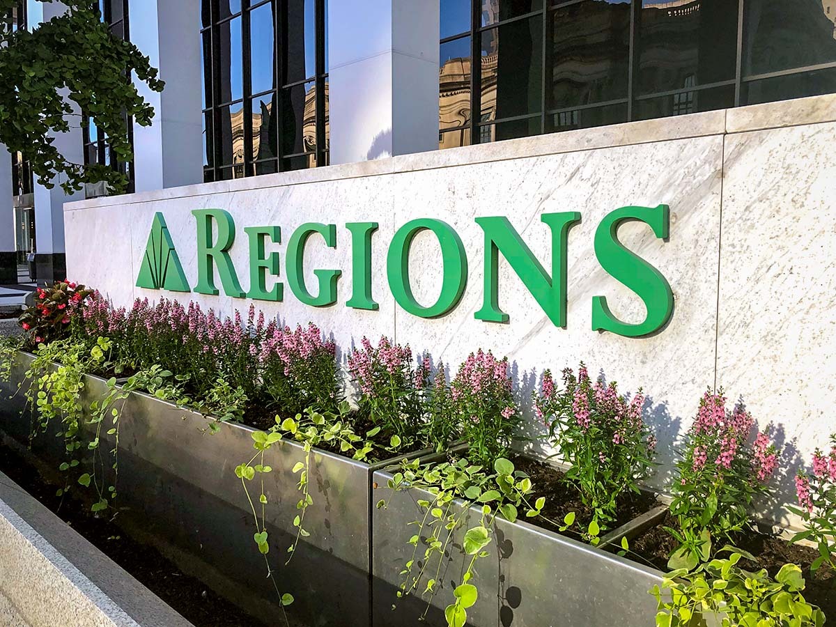 Close up of entrance signage and landscaping on the Regions Indianapolis Tower.