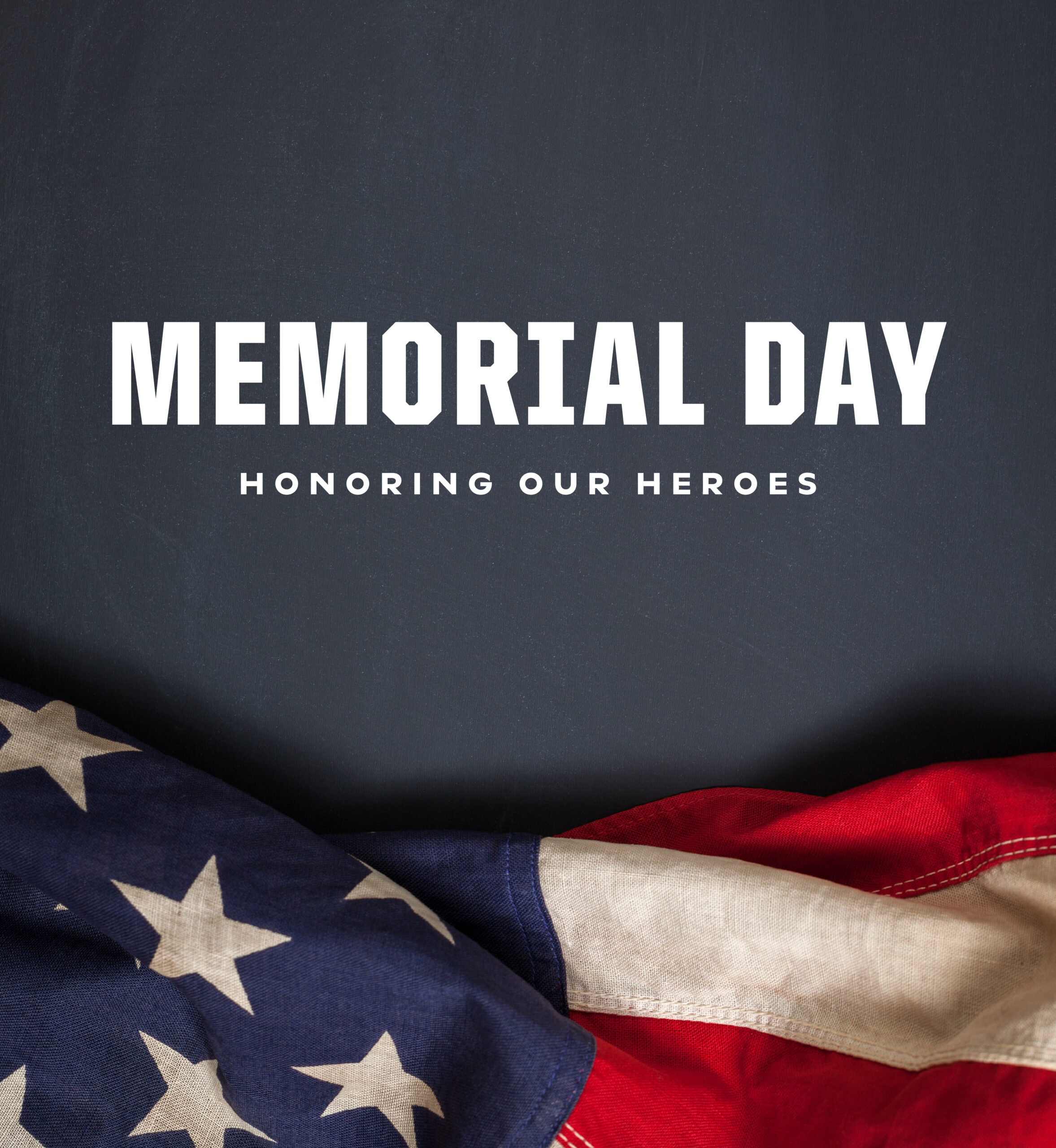 Edge of American flag against dark background. Text: Memorial Day. Honoring Our Heroes.