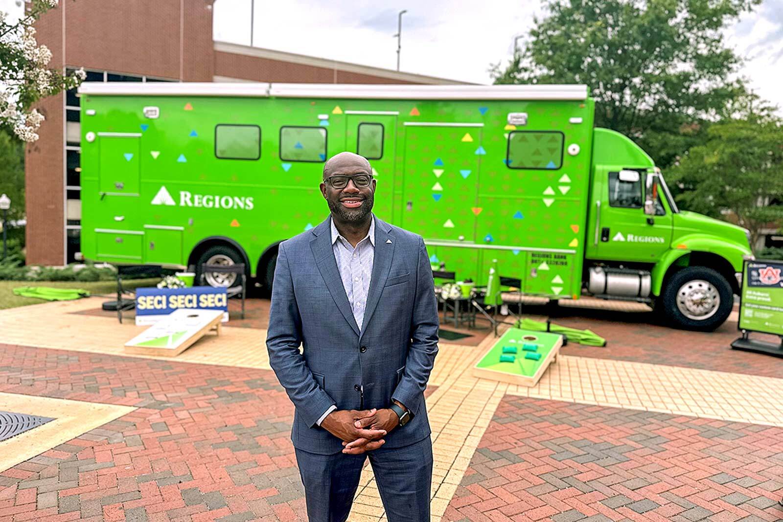 Associate from Regions Bank standing in front of the mobile...
