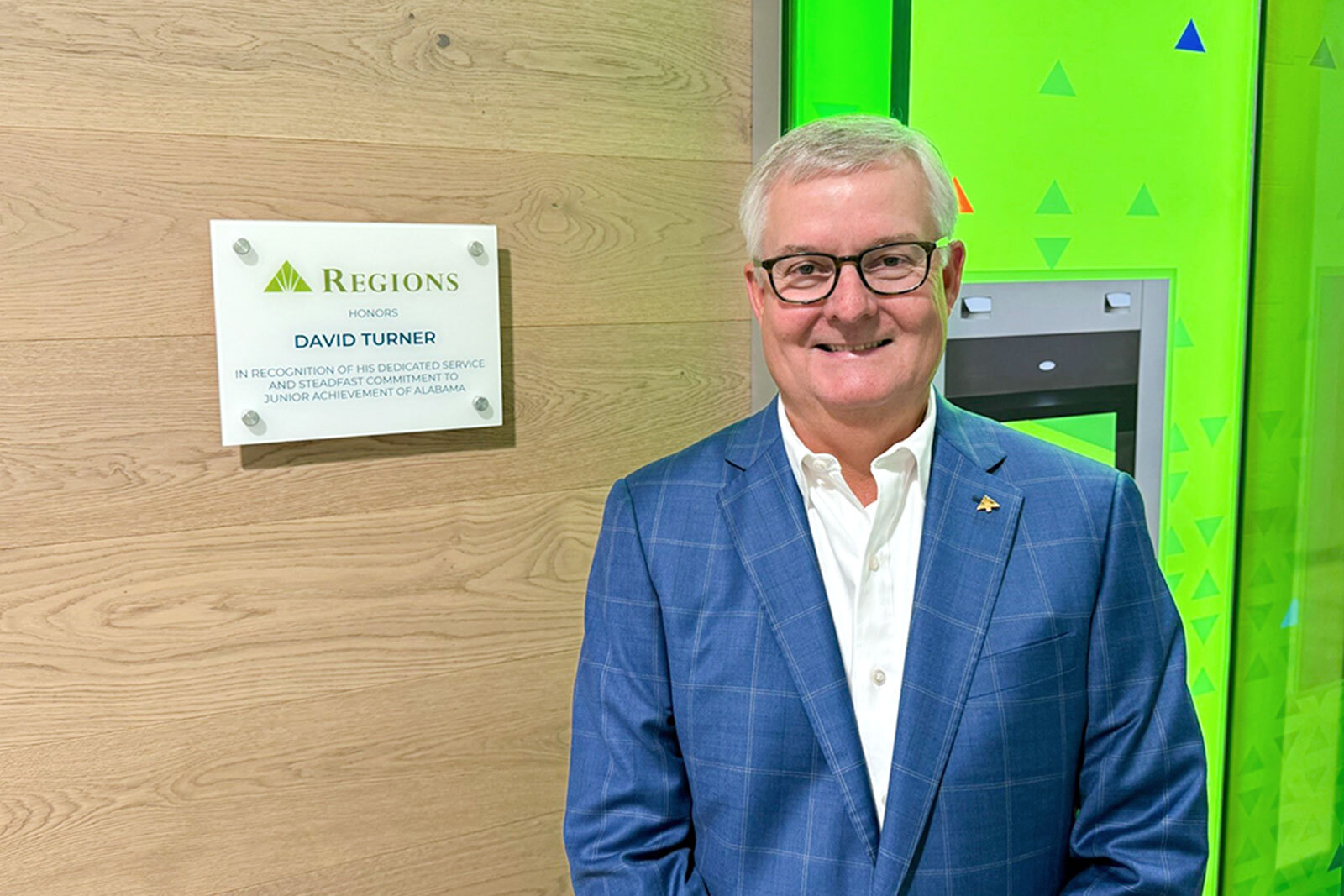 Retired Regions CFO David Turner stands inside a simulated Regions Bank branch.