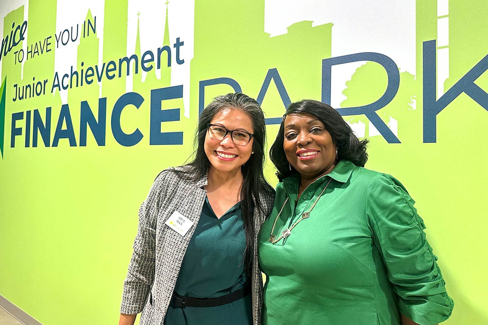 Regions Bank leaders Gina Sian and Lajuana Bradford stand inside JA Finance Park Presented by Regions.