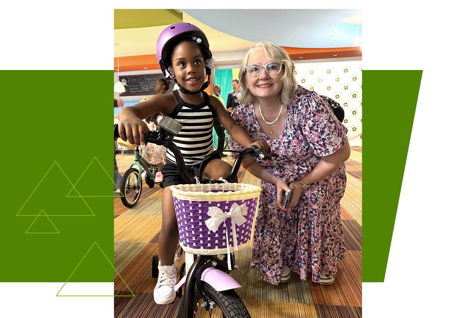 Michelle Ficklen poses with a young girl and her new bicycle.