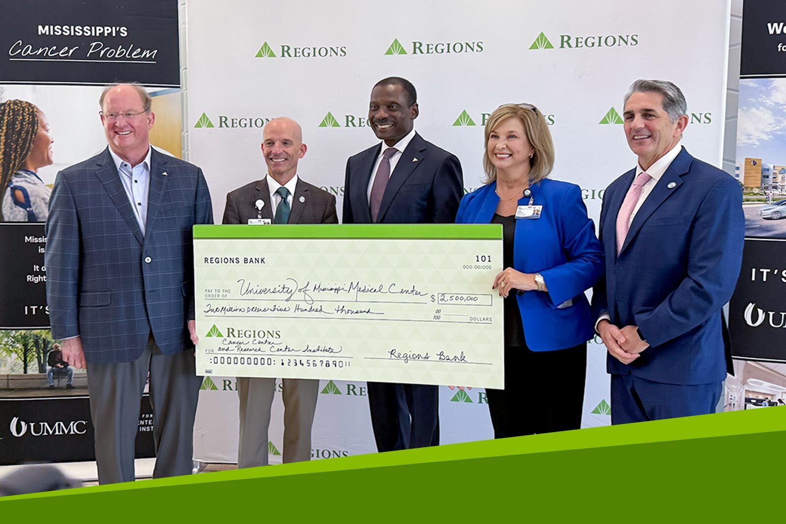 Regions associates and UMMC standing in front of Regions backdrop...