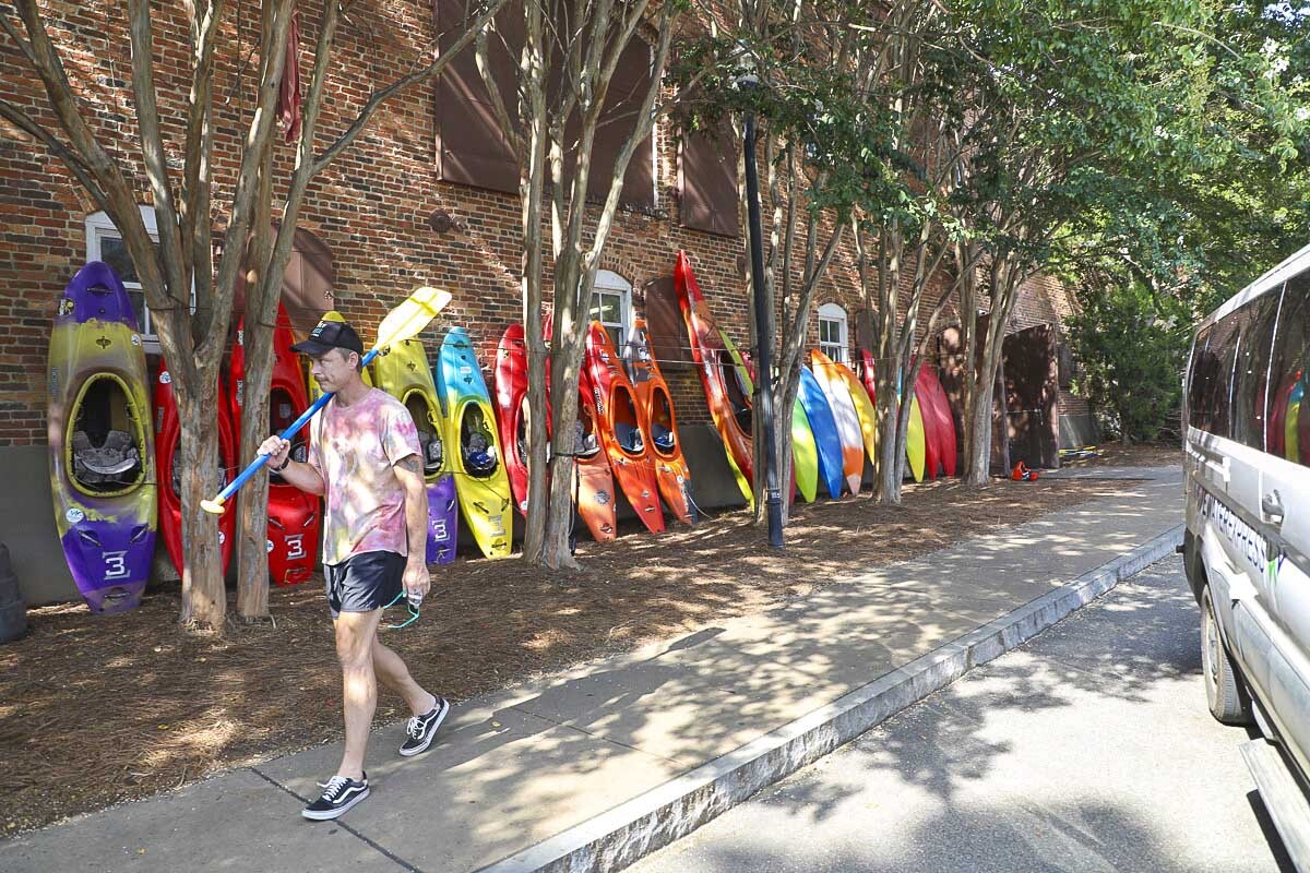 A whitewater guide heads to the bus transporting adventurers to their launch site.