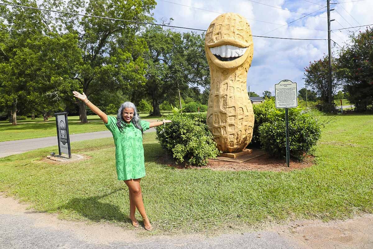 Kristina Justice has seen the Plains Peanut many times during her tenure at Regions. But she still graciously poses for a photo to help us remember our road trip.