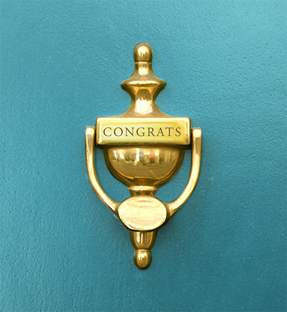 Door knocker with "congrats" engraved on it.