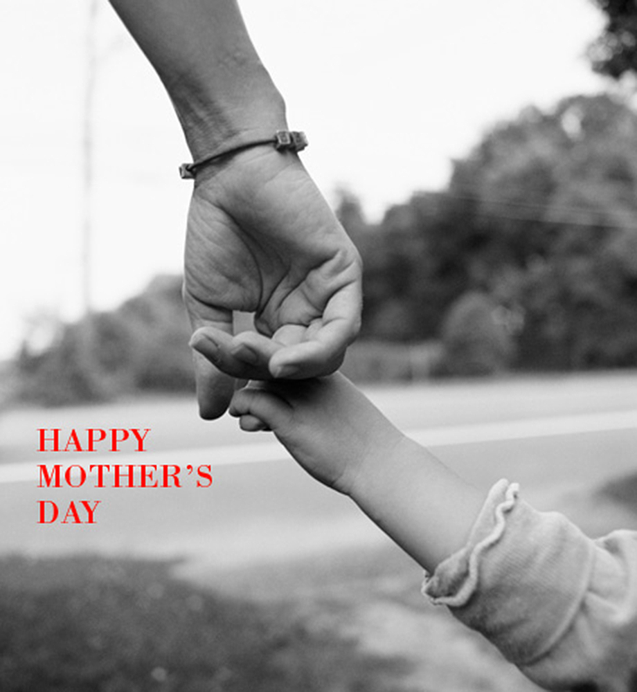 Mother holding child's hand. Text: Happy Mother's Day.