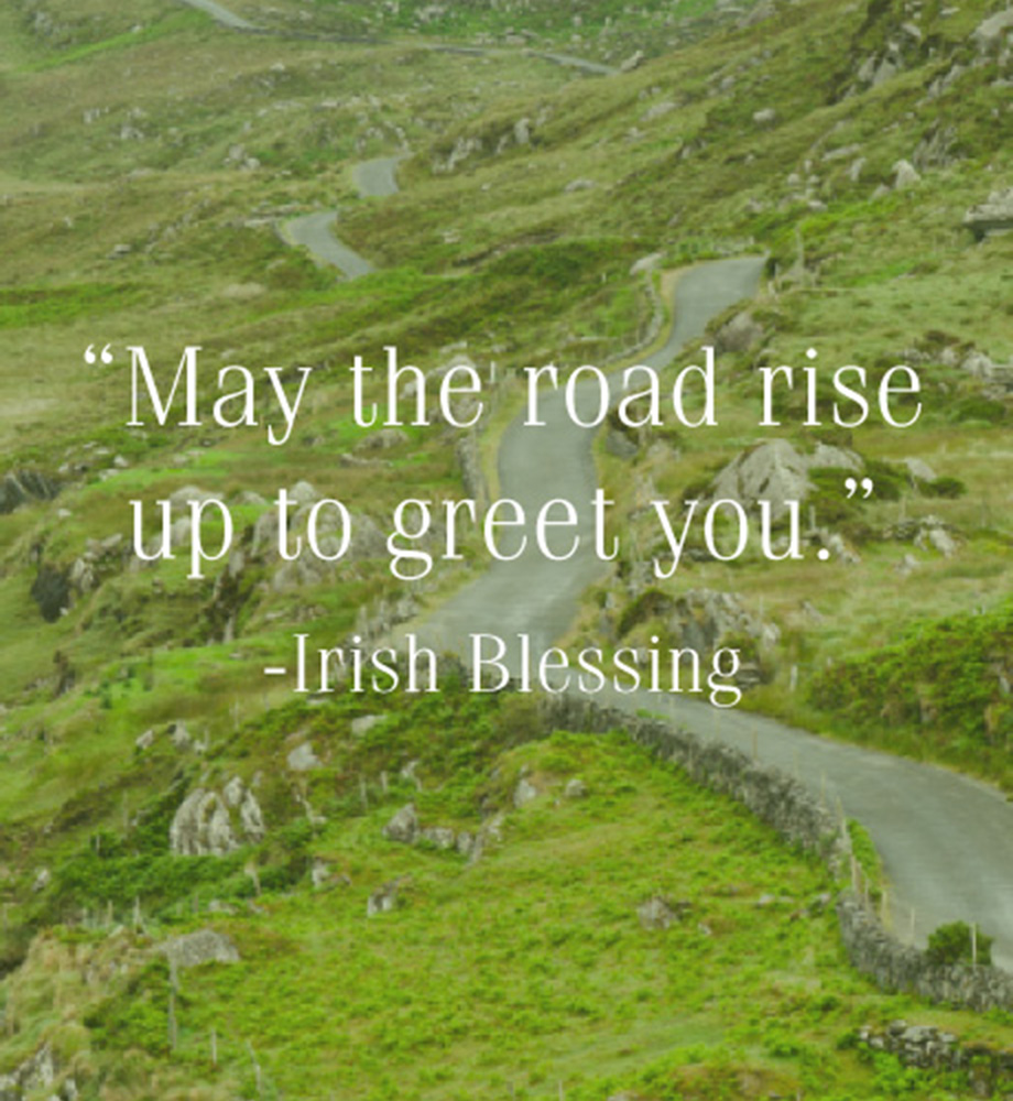 Winding road through hillside. Text: "May the road rise up to greet you" - Irish Blessing.