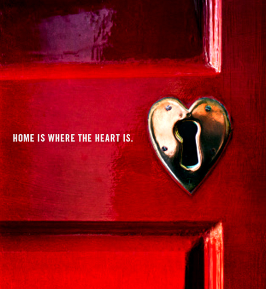 Close up of heart shaped keyhole on door. Text: Home is where the heart is.
