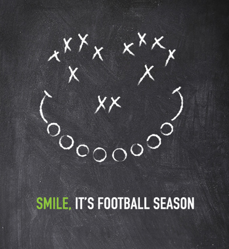Football play diagram in the shape of a smiley face on chalkboard. Text: Smile, it's football season.