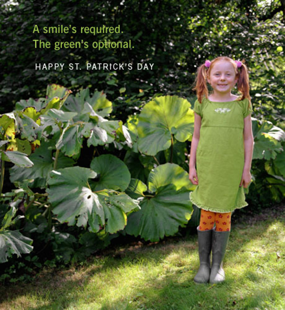 Smiling young girl wearing green dress. Text: A smile's required. The green's optional. Happy St. Patrick's Day.