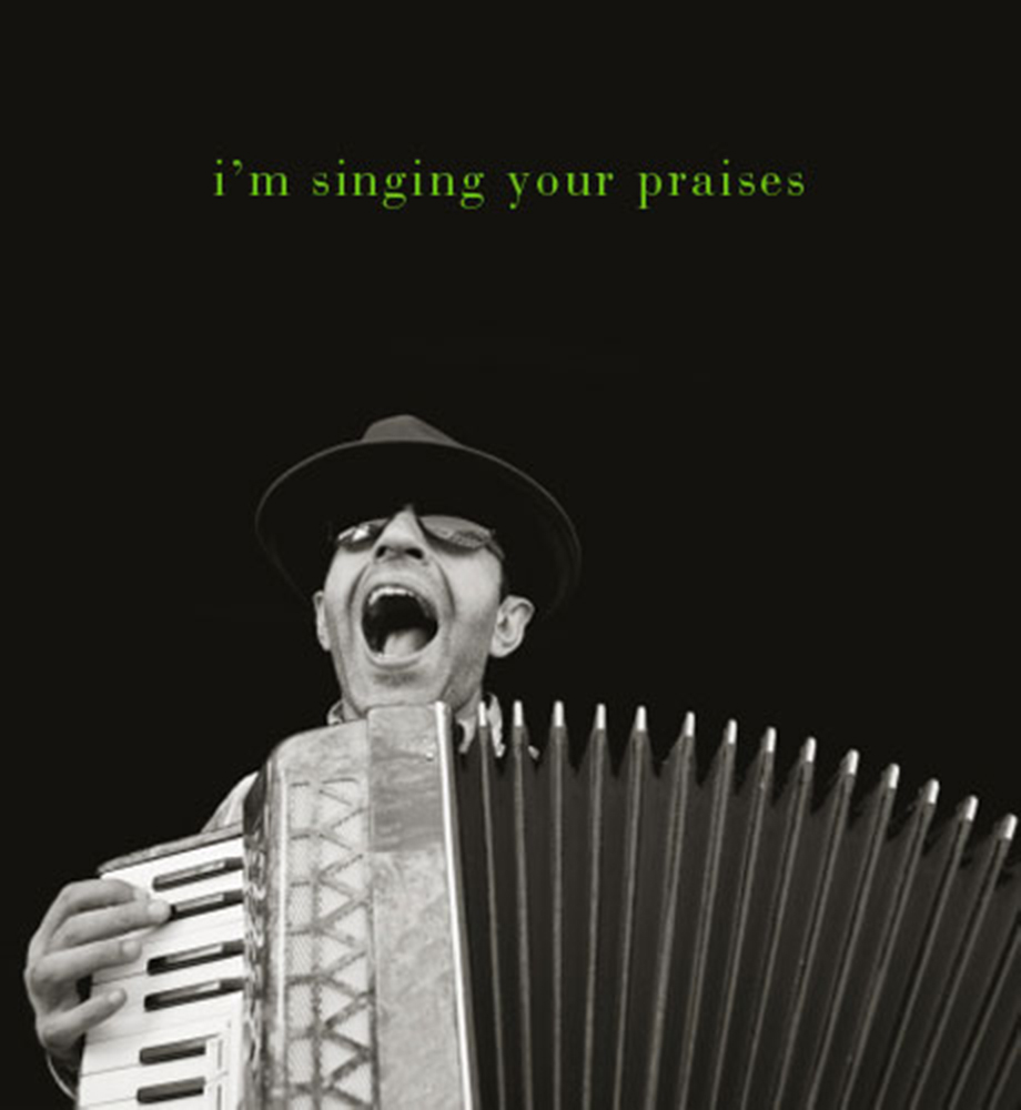 Man playing accordion and singing. Text: I'm singing your praises.