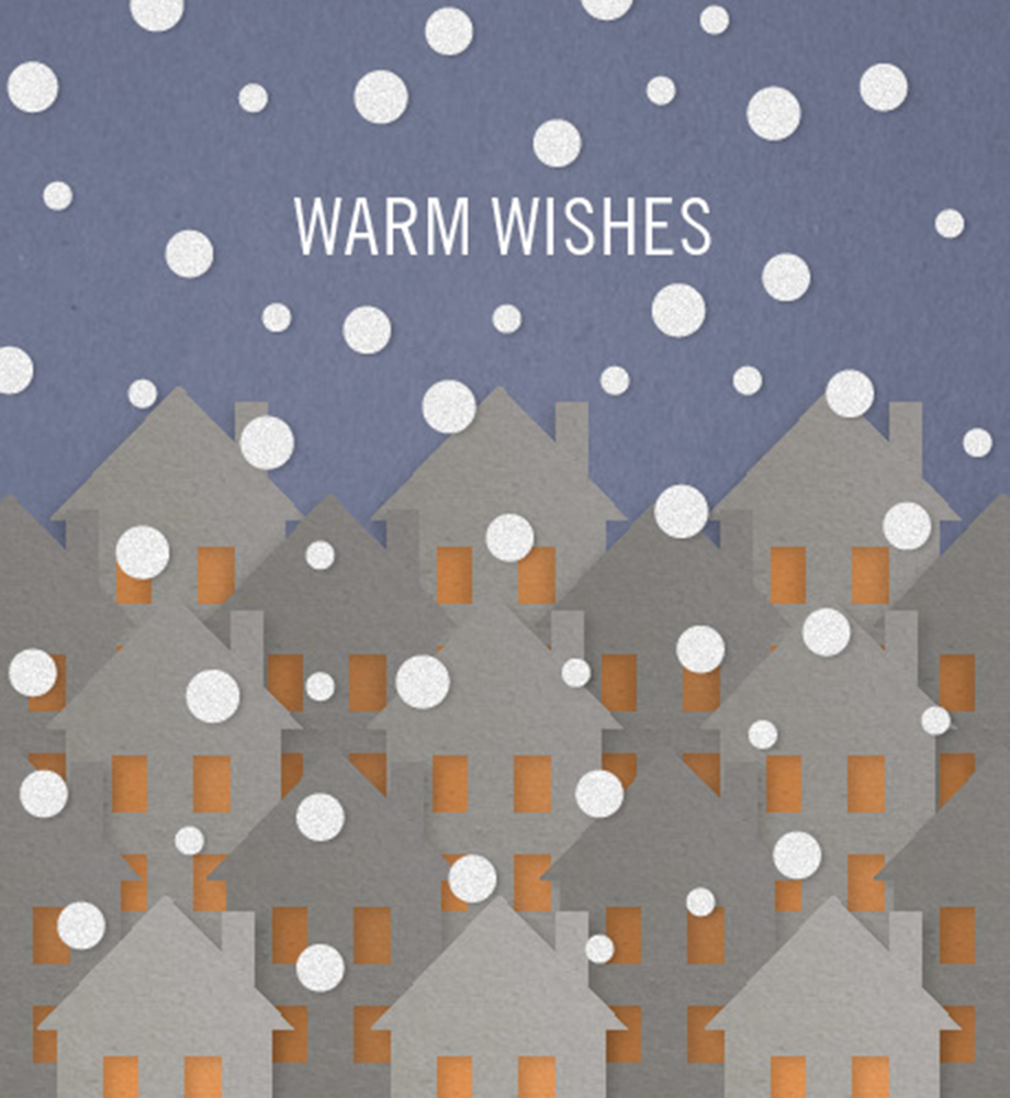 Paper cutout houses with falling snow. Text: Warm Wishes.